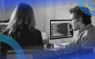 What Is Data Modeling? Data modeling image of a man and a woman looking at a computer screen covered with code on it.