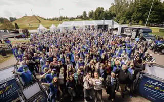 A large crowd of Devbridge employees pose during a team outing.