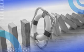 Financial risk management image of wooden Jenga blocks falling like dominoes but they're stopped by a mini life preserver.