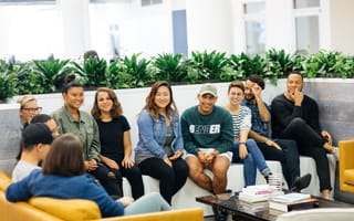 Photo of Foursquare employees gathered on a couch.