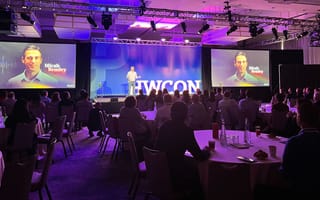 Robin's CEO speaking on stage at a conference.