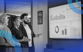 Marketing Operations image of two men and a woman looking at a television with a data presentation.