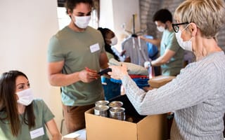 Group of people handing doing volunteer work.