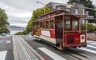 photo of SF cable car in the street on an overcast day