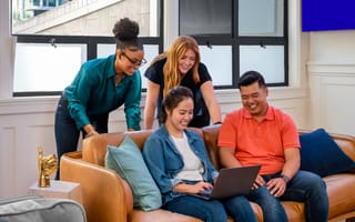 SoFi team members sitting together on a couch