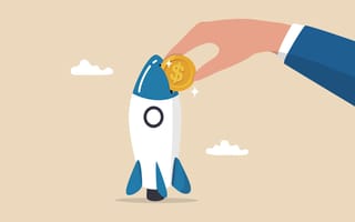 A cartoon hand puts a coin into a cartoon rocketship.
