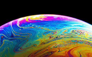 A close-up view of a bubble reflecting a rainbow of colors.