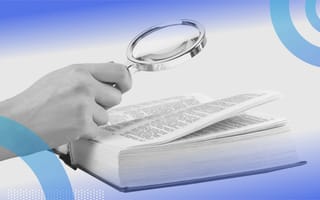 A person looking through an open dictionary.