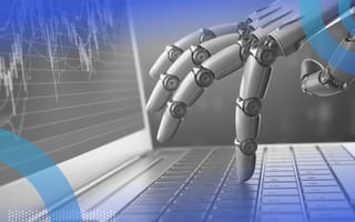 A robotic hand works on a laptop with stock data