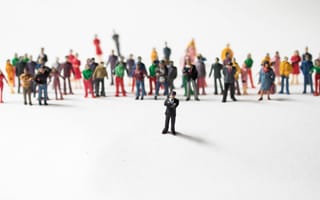action figure of a person standing in front of an assortment of others in the background