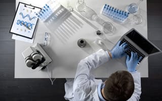 Bioscience employee working on a computer.