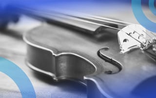 A violin laying on a table.