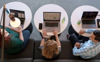 AlertMedia team members working together on laptops