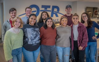 A group of people in two rows pose for a photo