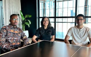 Rivet co-founders Anj Fayemi, Simran Pabla and Saad Rahman sit around a table in an office.