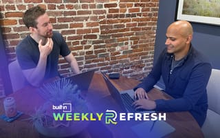 Clearly co-founders chat with each other in an office.