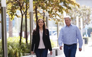 DIRECTV's Kamilah Jackson walking outside of the company's offices with a colleague