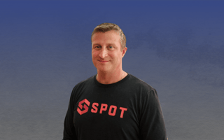 Spot co-founder Andrew Elsener against a blue and grey background.