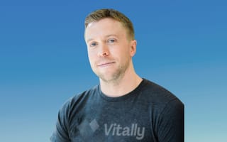 Vitally founder and CEO Jamie Davidson is pictured against a blue background.