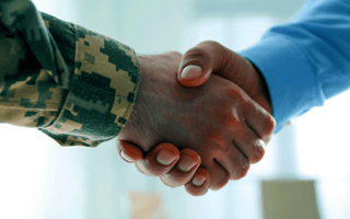 A veteran shaking hands with an employer hiring them for a job.