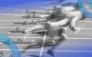 A group of sprinters leave the blocks in a race