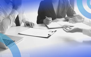 10 Common SQL Interview Questions Three people sit around a table at a job interview