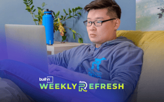 A Coding Dojo employee works on a laptop.