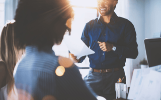 Stock image of workplace people in meeting, smiling