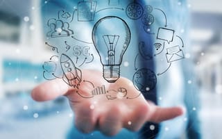 A hand holding a hand drawn lightbulb surrounded by multimedia icons.