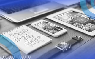 responsive web design image of a desk holding a smart watch, a smart phone, a tablet and a laptop with a sketchpad