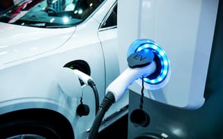 An electric vehicle connected to a charging station.
