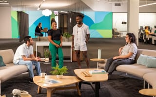 sprout social team members conversing with each other in the office