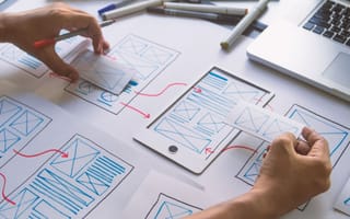 A designer works on user journey maps.