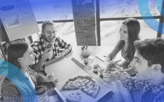 People eating pizza at an office. To get employees bac to the office, offer connections not possible in a virtual setting.