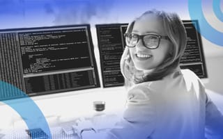 A woman smiles while working at a computer terminal