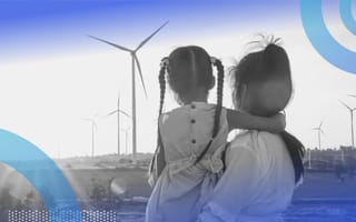 A woman and little girl look at wind turbines