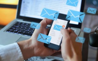 A person checks their email on their phone.