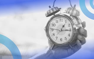 A hand holding a clock. Product-moment fit means making sure a product is right for the cultural and economic times.