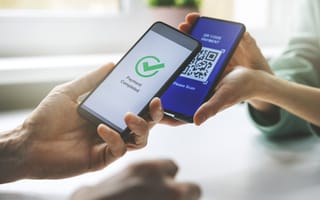 A phone scans a QR code to make a digital payment.