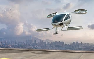 A generic eVTOL aircraft approaches a landing pad.