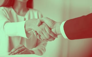 An applicant accepts a job offer by shaking the hiring manager's hand.