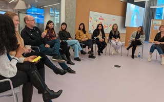 employees sitting in chairs in a circle