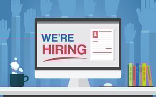 Graphic illustration of desk with computer monitor with words "We're Hiring"