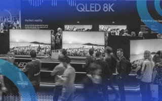 A group of people check out smart TVs at an exposition hall