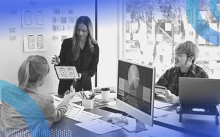 A designer shows a tablet computer to her colleagues