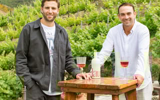 The Naked Market co-founders Harrison Fugman and Alex Kost pose for a photo with Haus brand drinks.