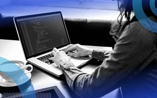 person writing code on laptop
