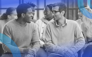 Two men talking at work. Safe spaces, such as employee resource groups, can help LGBTQ+ employees thrive in the workplace.