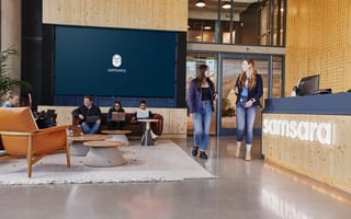 two women walking in an office