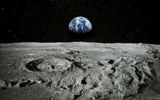 Footprints on the moon sit in the image foreground with a portion of Earth visible in the distance.